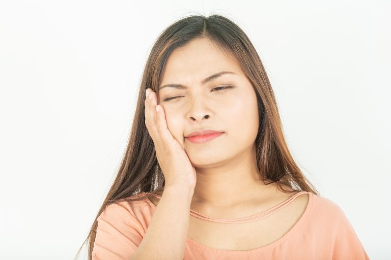 A woman with her hand on her cheek.