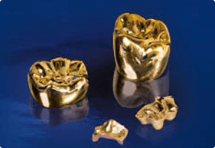 A set of gold teeth on a blue background.
