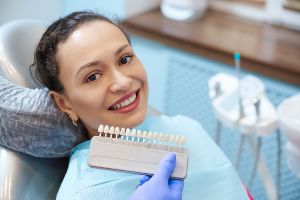 A woman is sitting in a dentist's chair.