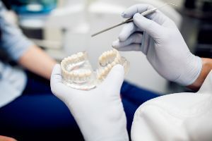 A dentist is examining a patient's teeth.