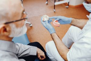 A dentist is examining a patient's teeth.