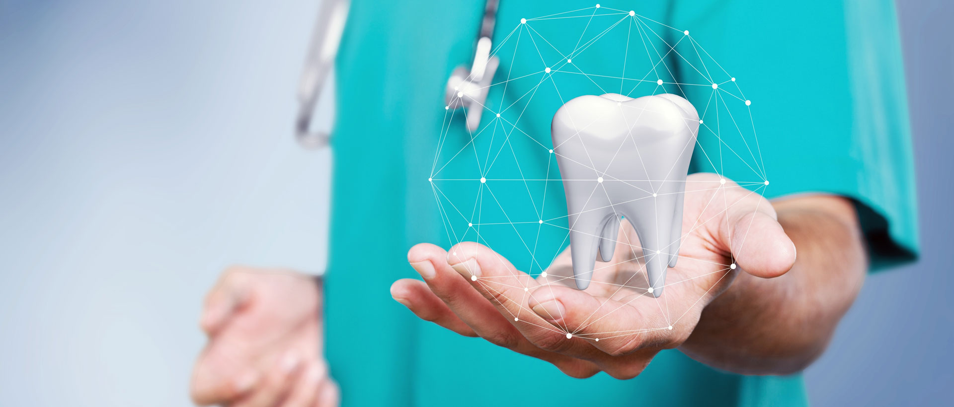 A dentist holding a tooth in his hands.